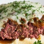 Crockpot French Onion Meatloaf with Melted Swiss Cheese served on a plate