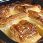 A serving of Reuben Crescent Bake with golden, flaky crust, melted Swiss cheese, corned beef, and sauerkraut.