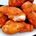 Crispy and golden-brown Popeye's CopyCat fried chicken with a spicy Cajun seasoning crust and juicy interior.