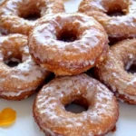Old-fashioned cake donuts with glaze and cinnamon sugar on a plate