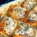 Baked Caesar Chicken topped with creamy Parmesan sauce served with a side of roasted vegetables.