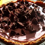 Slice of old-fashioned chocolate pie with meringue topping and flaky crust