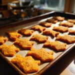 Close-up of freshly baked Salmon & Sweet Potato Cat Treats on a baking sheet.