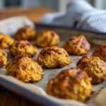 Close-up of baked 4-ingredient Tuna & Pumpkin Cat Bites on a baking sheet.