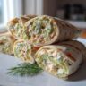 Close-up of Cucumber Dill Cream Cheese Pinwheels, showing cucumber, dill, and cream cheese filling.